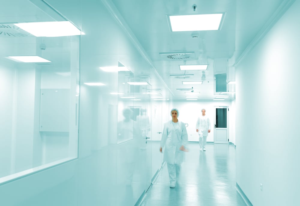 Modern bright factory interior with working people in motion